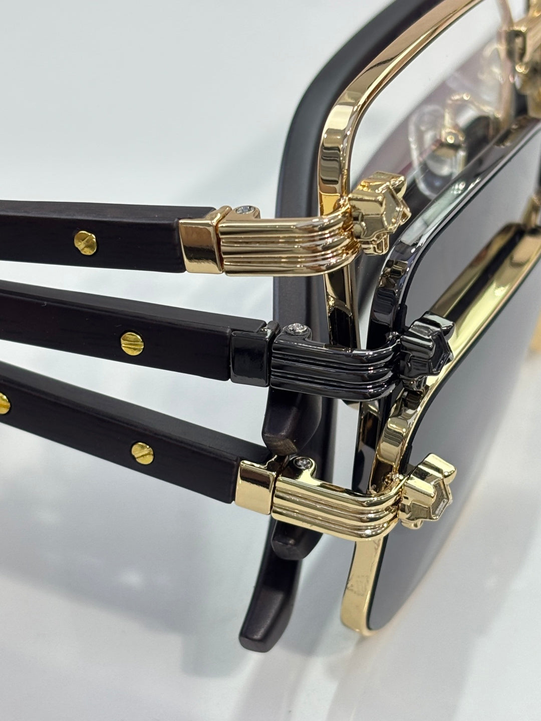 Cartier glasses close-up of black temples with gold metal hinge details