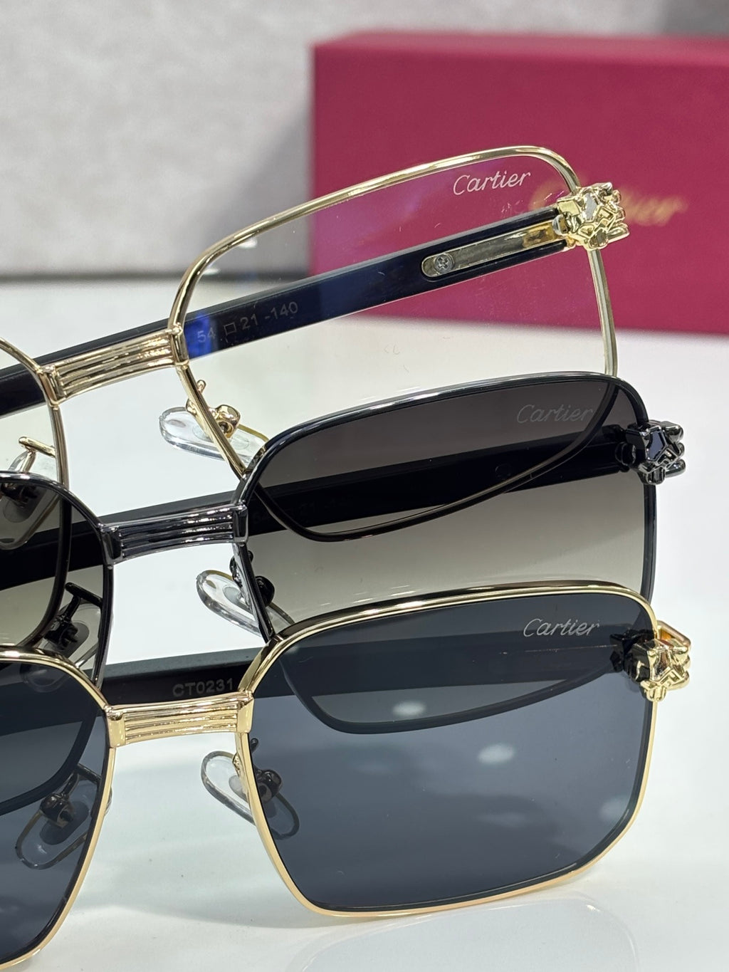 Cartier sunglasses stacked view with gold-tone frame and dark lenses