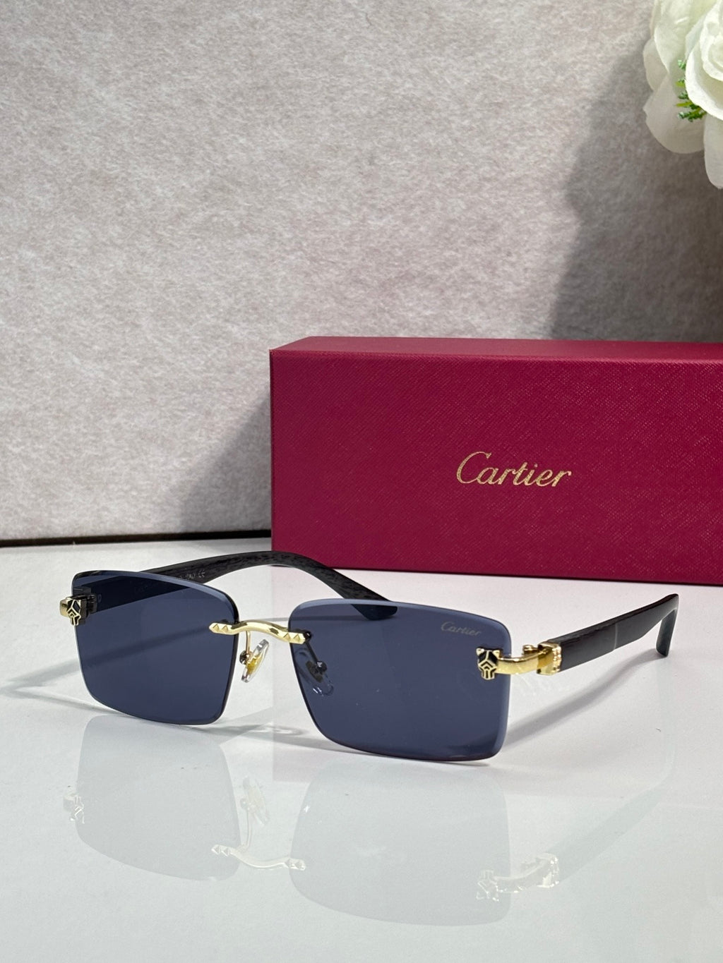 Cartier eyeglasses, dark frame with navy lenses and gold hinge detail