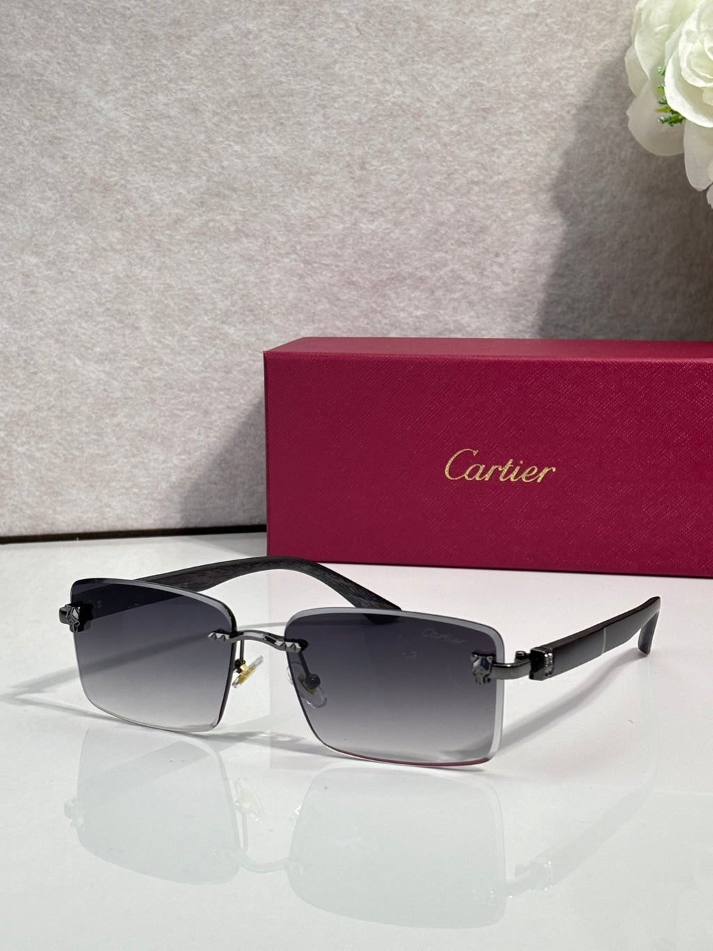 Cartier eyeglasses, dark frame with dark-gray gradient lenses and gold hinge detail