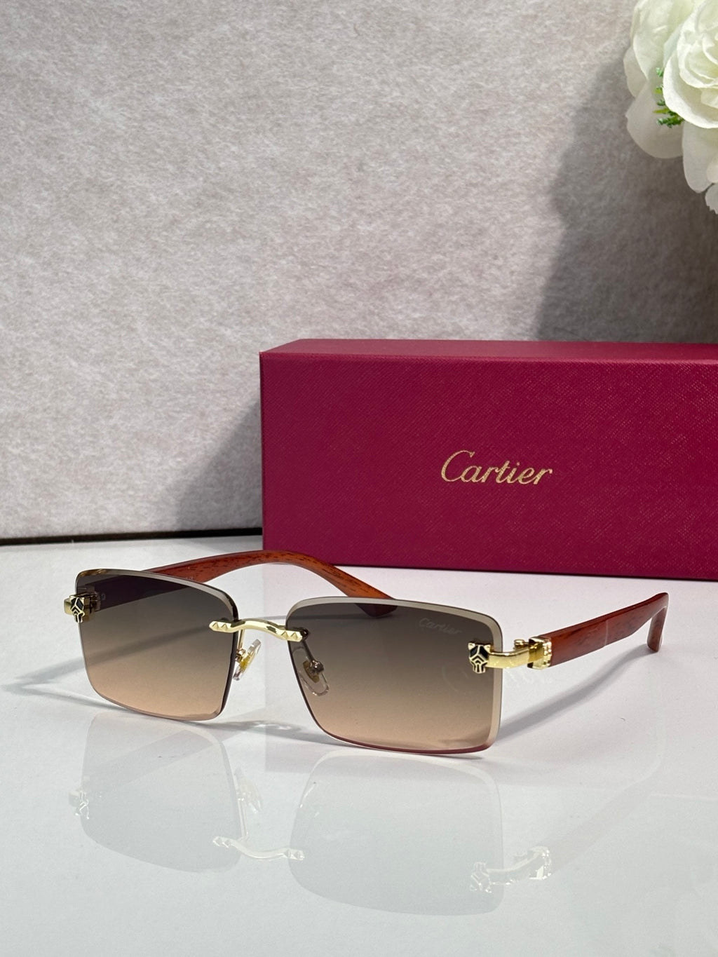 Cartier eyeglasses, dark frame with brown tinted lenses and gold hinge detail