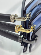 Cartier eyeglasses close-up, gold and silver hinge hardware on dark frame