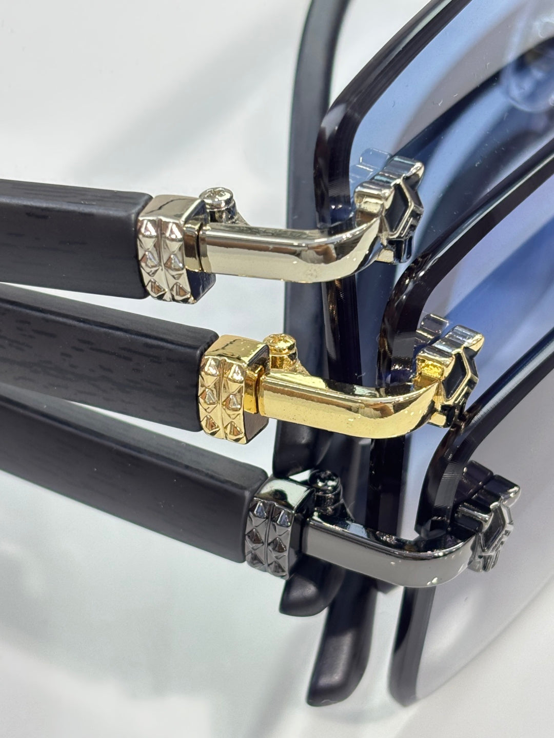 Cartier eyeglasses close-up, gold and silver hinge hardware on dark frame