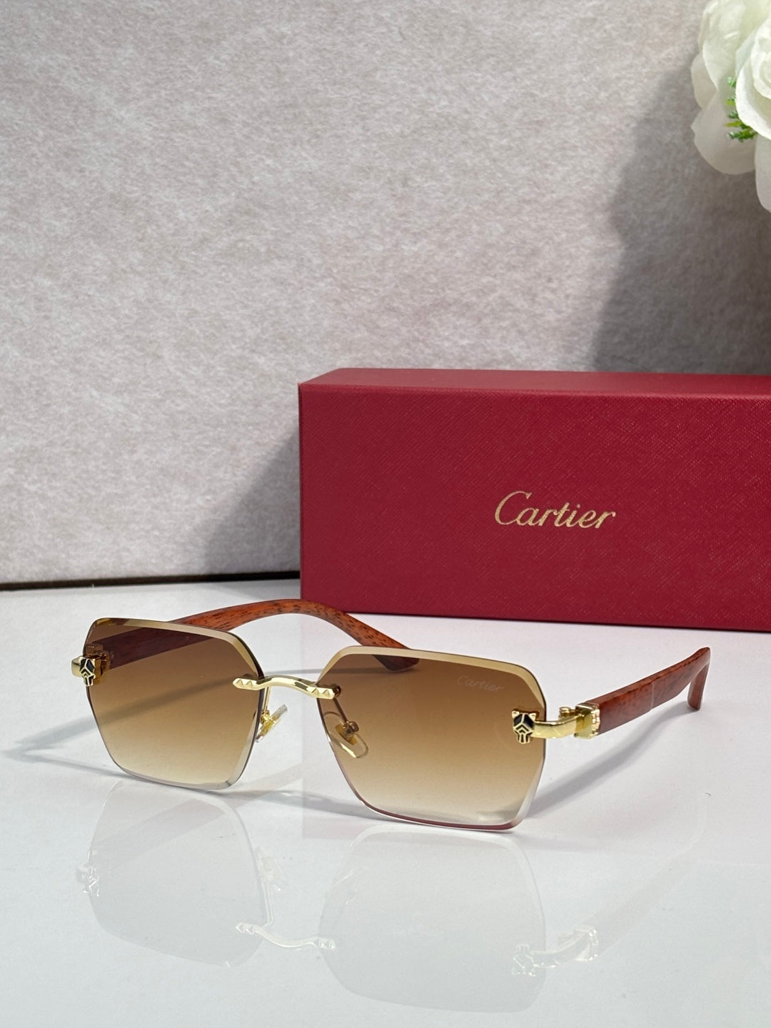 Cartier sunglasses with amber lenses, tortoiseshell frame, and gold-tone accents