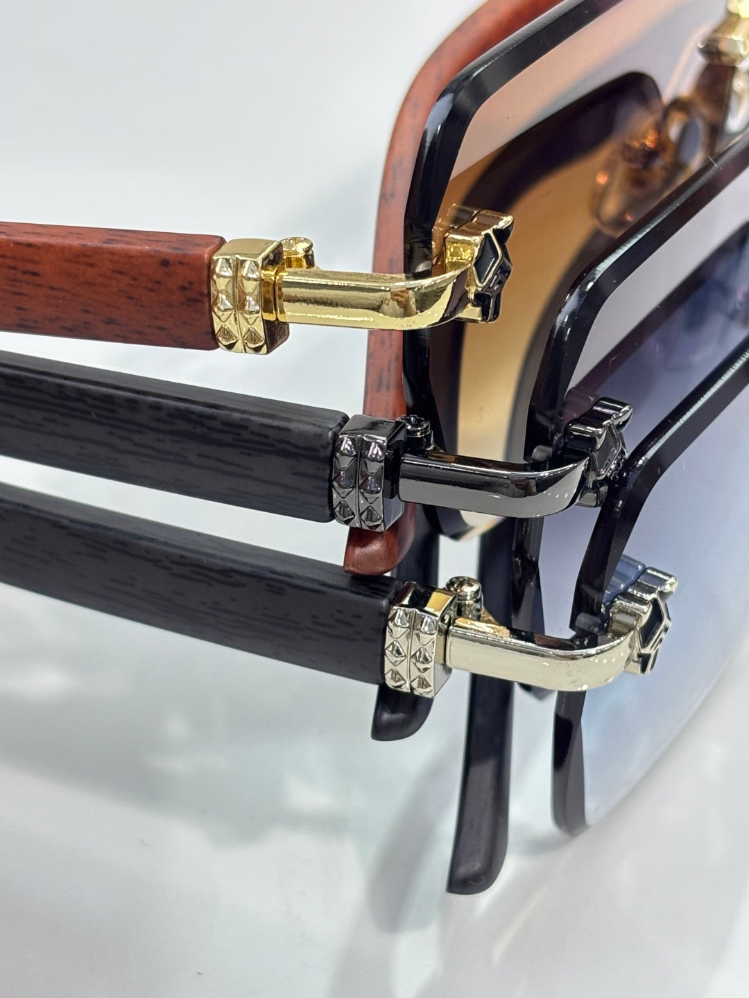 Cartier sunglasses temple close-up with gold-tone and black decorative links