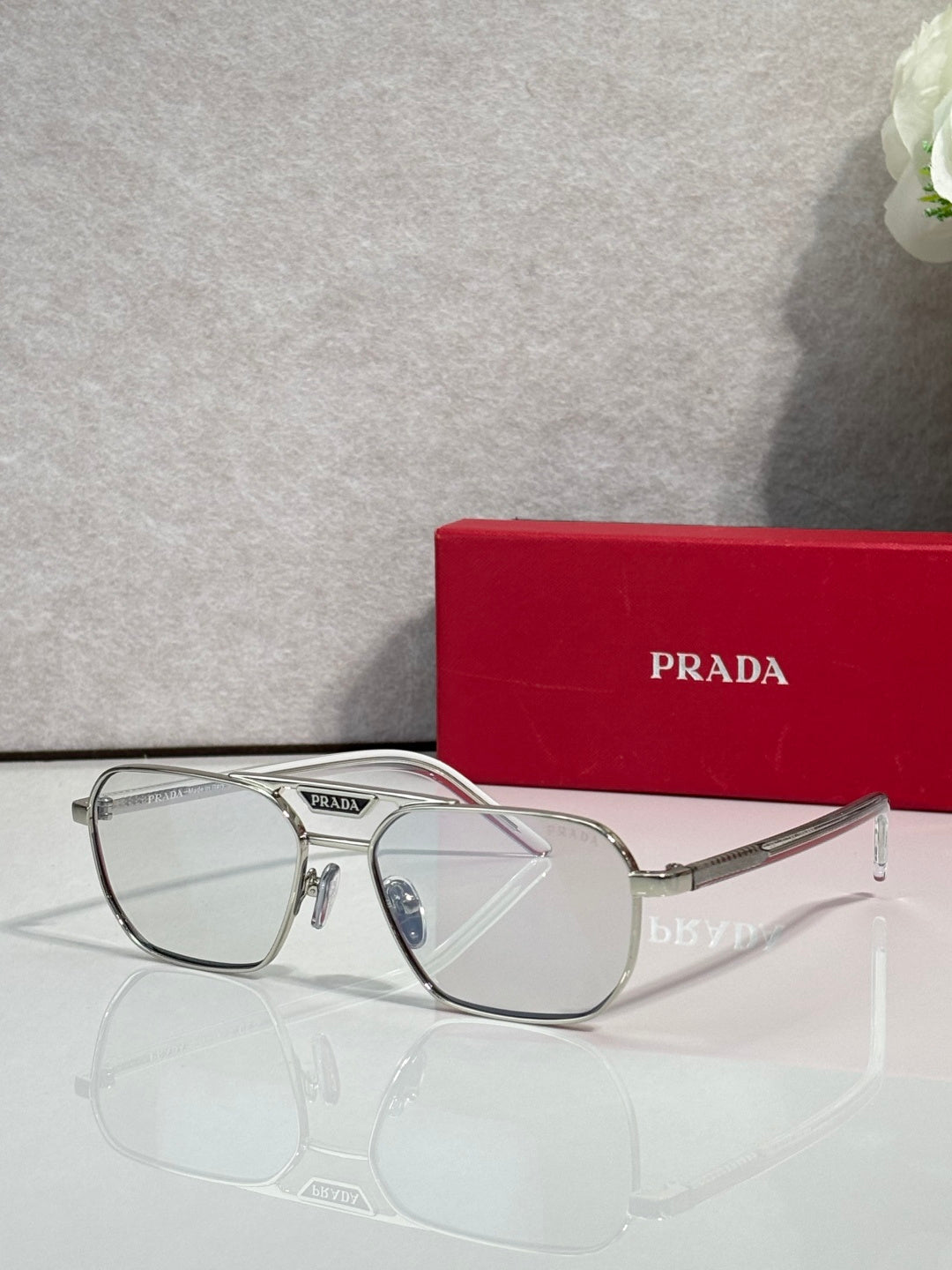 Silver eyeglasses with rectangular frames and clear lenses