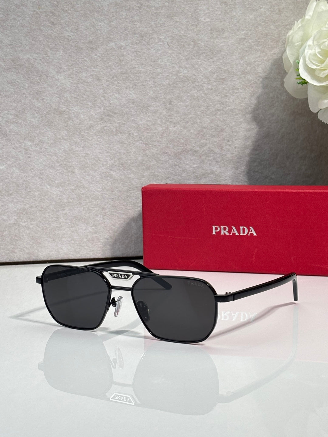 Black sunglasses with rectangular frames and dark lenses