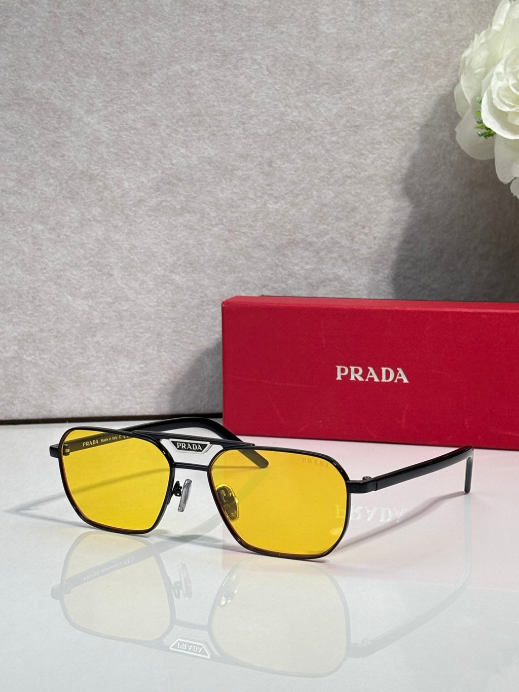 Yellow-lensed sunglasses with rectangular black frames