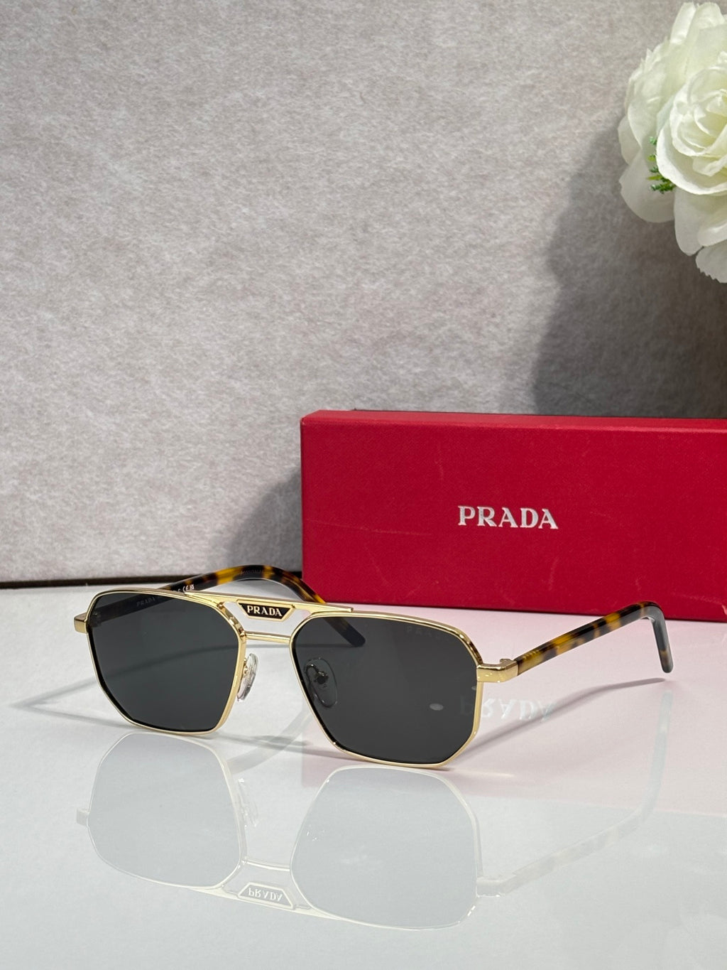 Tortoise and black sunglasses with rectangular frames and dark lenses