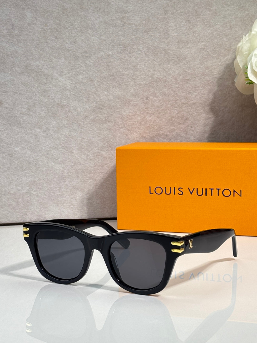 Louis Vuitton sunglasses with black frames and dark lenses