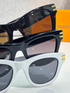 Black and white Louis Vuitton sunglasses with dark lenses and gold temple hardware