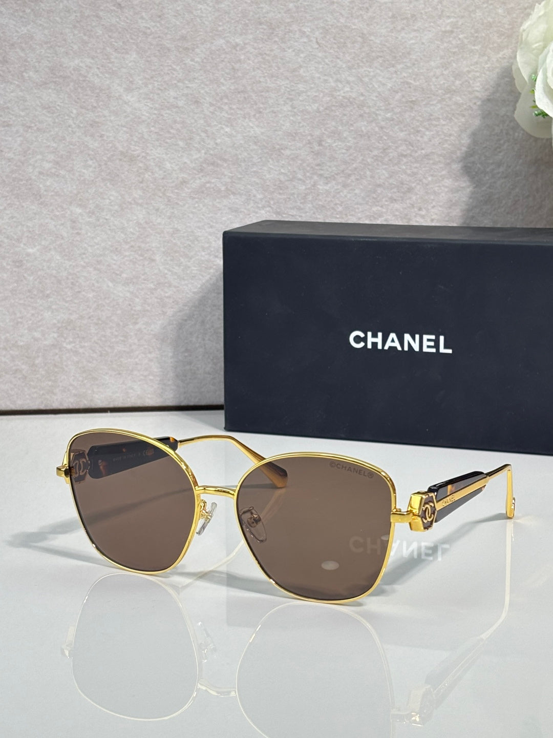 Chanel sunglasses with gold-tone frame and brown tinted lenses