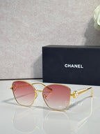 Chanel sunglasses with gold-tone frame and pink tinted lenses