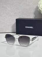 Chanel sunglasses with silver-tone frame and dark gray tinted lenses