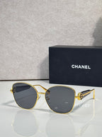 Chanel sunglasses with gold-tone frame and dark blue tinted lenses