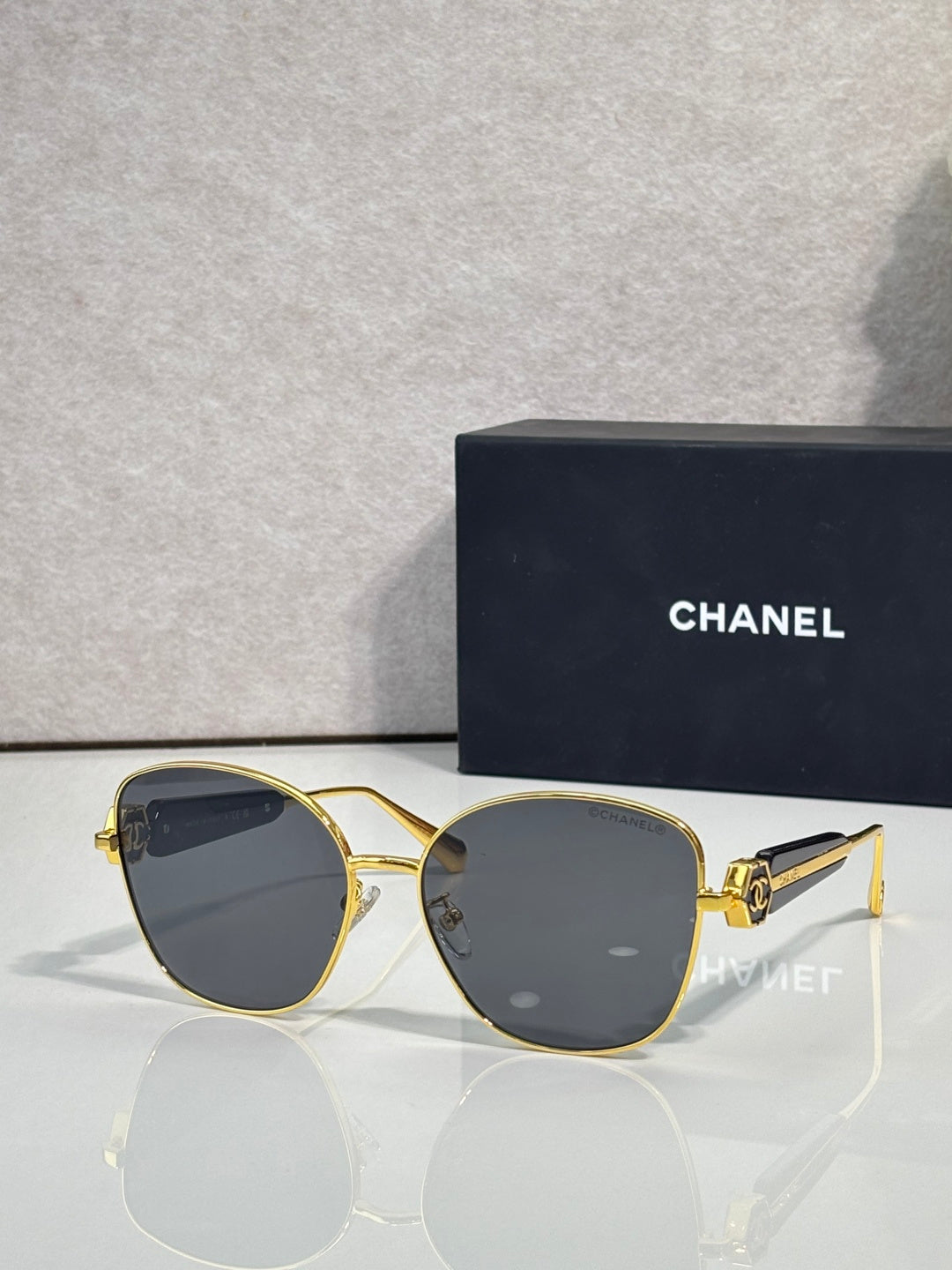 Chanel sunglasses with gold-tone frame and dark blue tinted lenses