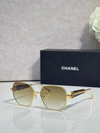 Gold-tone square sunglasses with light gradient lenses and metal hinge detail