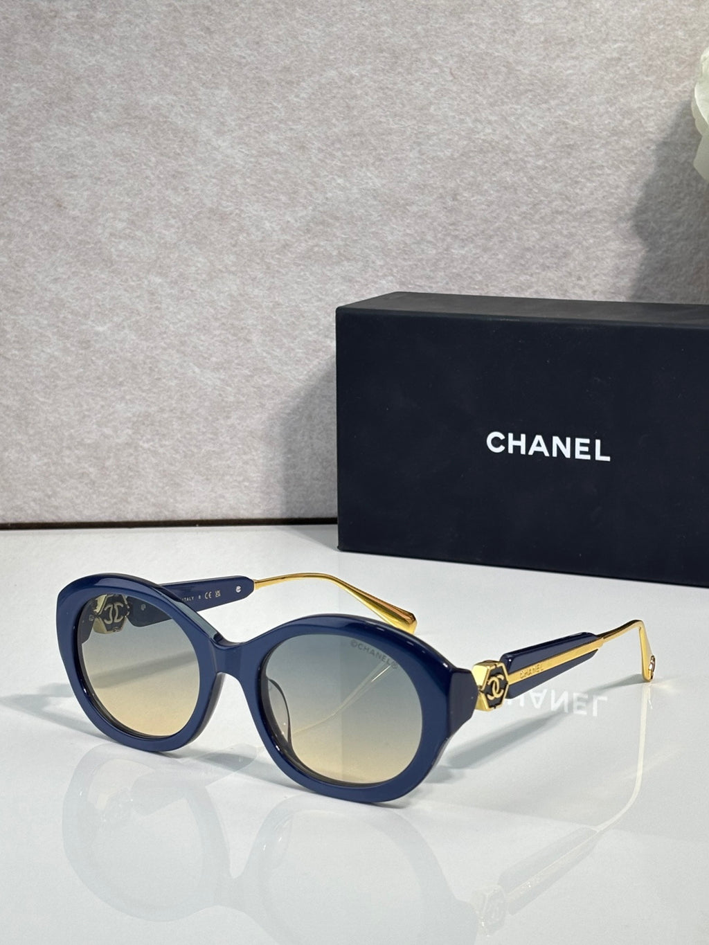 Chanel round sunglasses with blue frames and light lenses, gold-tone bridge hardware