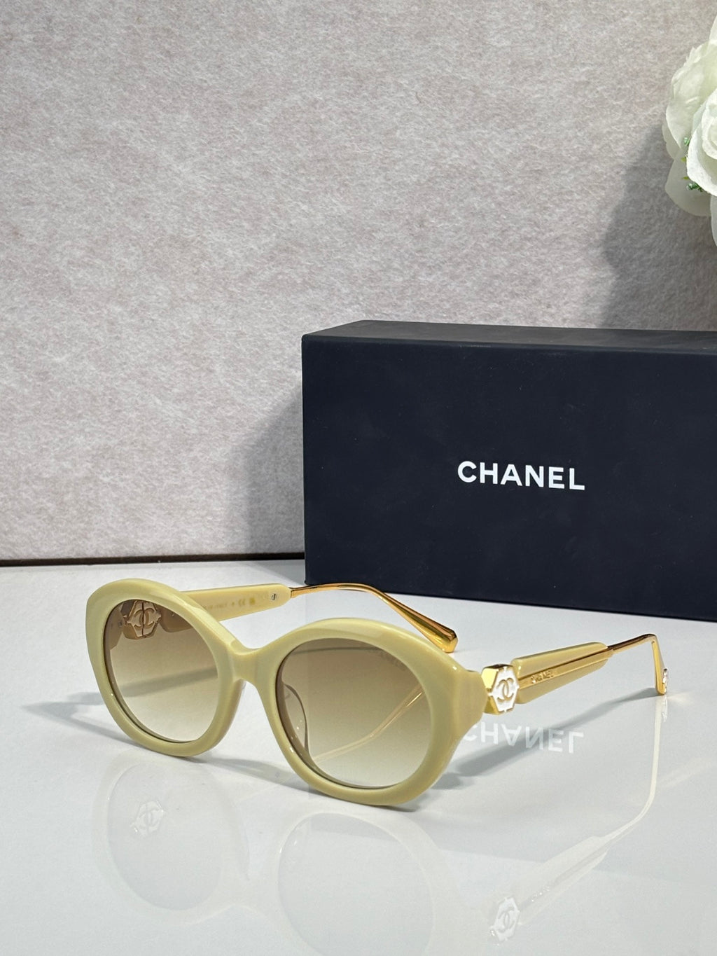Chanel round sunglasses with light green frames and tan tinted lenses, gold-tone arms