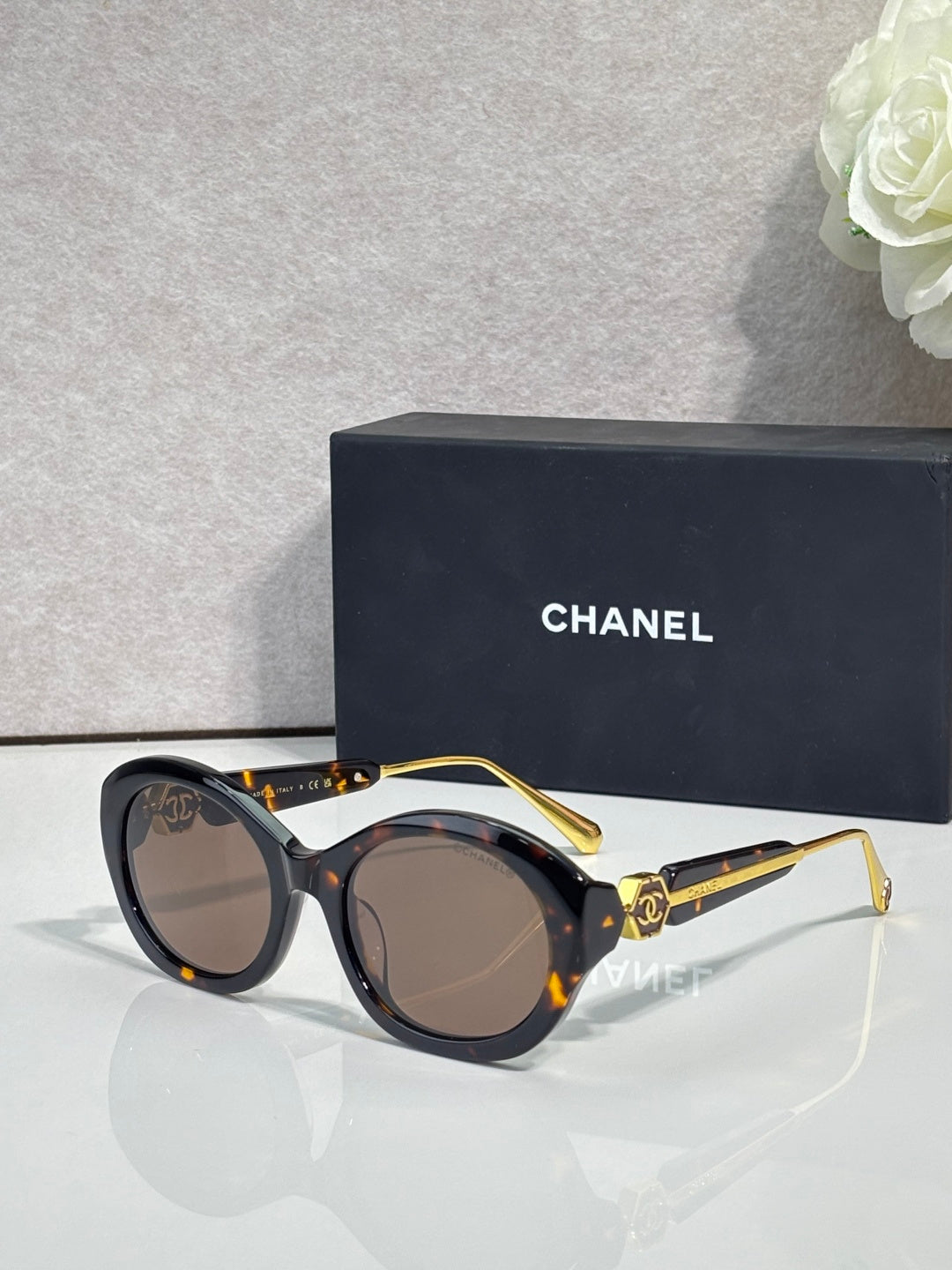Chanel round sunglasses with black frames and dark brown tinted lenses