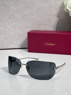 Cartier sunglasses with gold frame and dark navy shield lenses