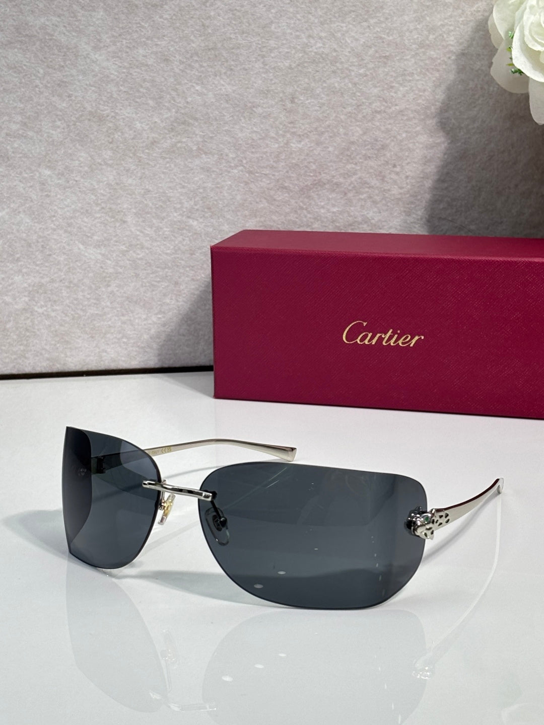 Cartier sunglasses with gold frame and dark navy shield lenses