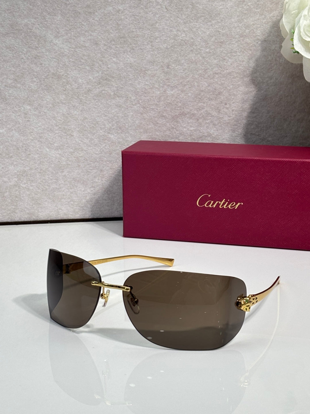 Cartier sunglasses with gold frame and dark smoke shield lenses