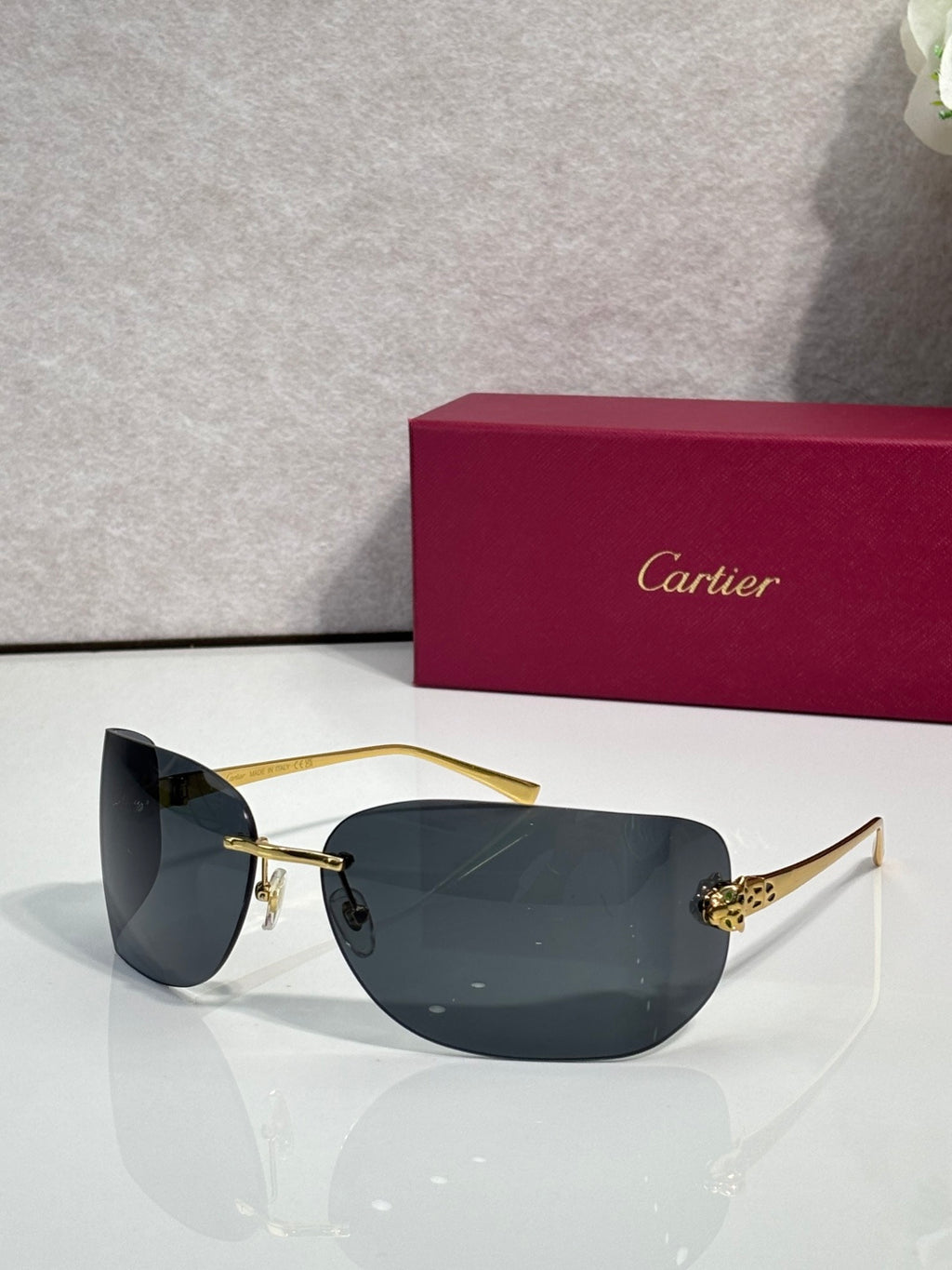 Cartier sunglasses with gold frame and dark charcoal shield lenses