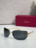 Cartier sunglasses with gold frame and dark charcoal shield lenses