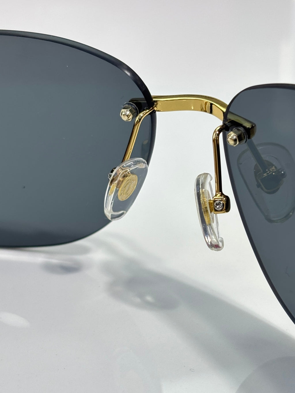 Cartier sunglasses close-up: gold frame with dark lenses and clear details