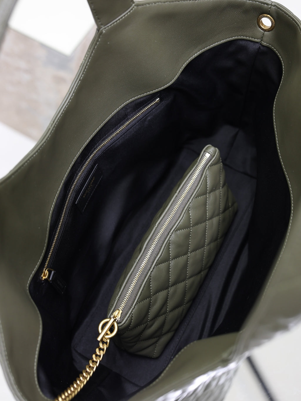 YSL tote bag interior view with quilted lining and zip pocket