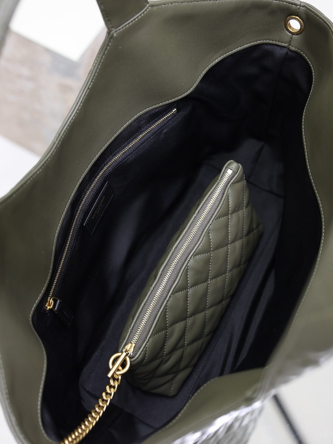 YSL tote bag interior view with quilted lining and zip pocket