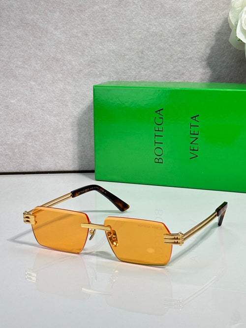 Bottega Veneta glasses with amber lenses, gold frame, and black temples