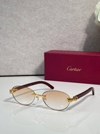 Cartier eyeglasses with dark brown frame and pale yellow lenses, gold temple details