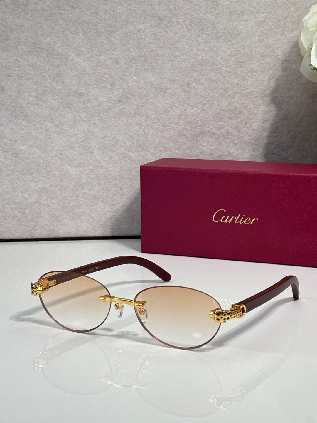 Cartier eyeglasses with dark brown frame and pale yellow lenses, gold temple details