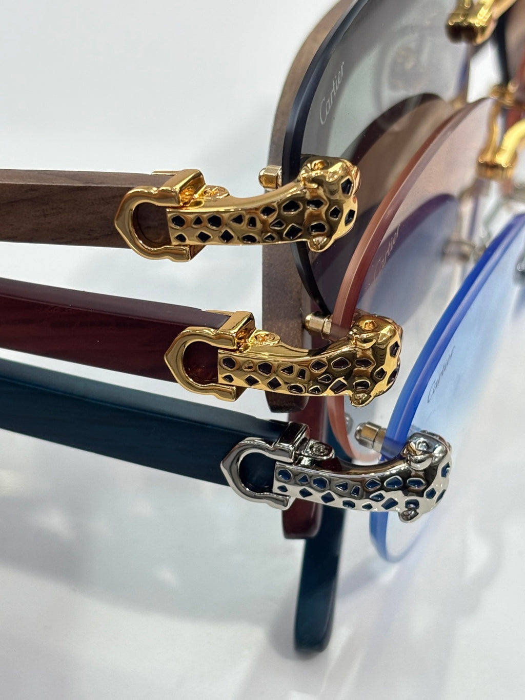 Cartier eyeglasses close-up: gold leopard-pattern hinges on clear frames