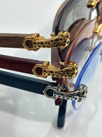 Cartier eyeglasses close-up: gold leopard-pattern hinges on clear frames
