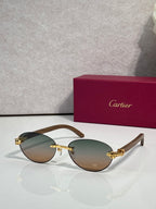 Cartier eyeglasses with dark brown frame and green-tinted lenses, gold hardware