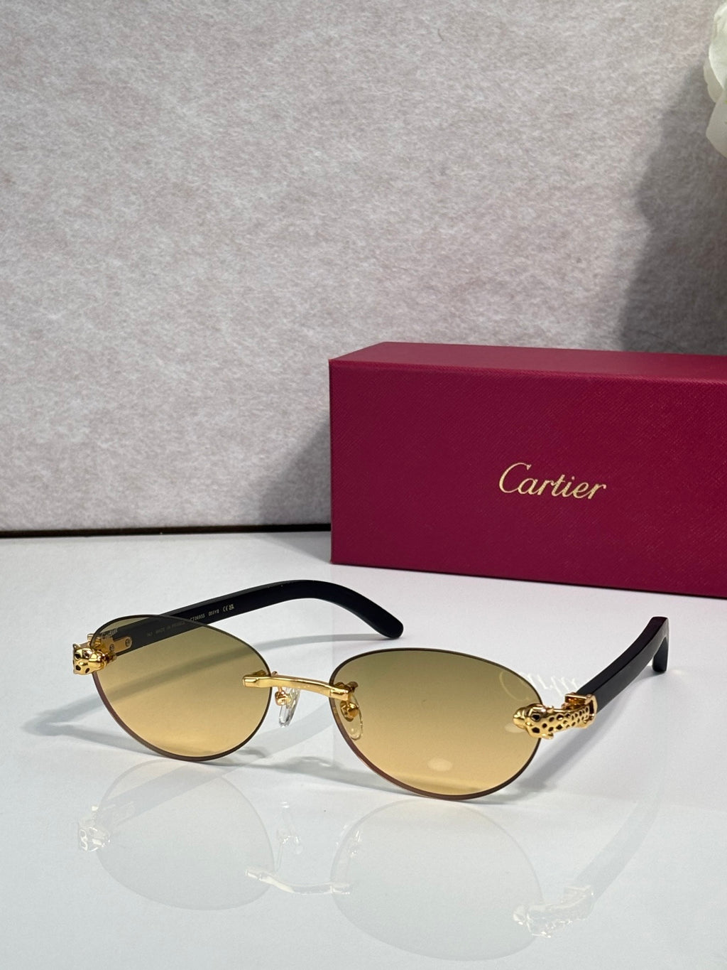 Cartier eyeglasses with dark brown frame and pale yellow lenses, gold temple accents