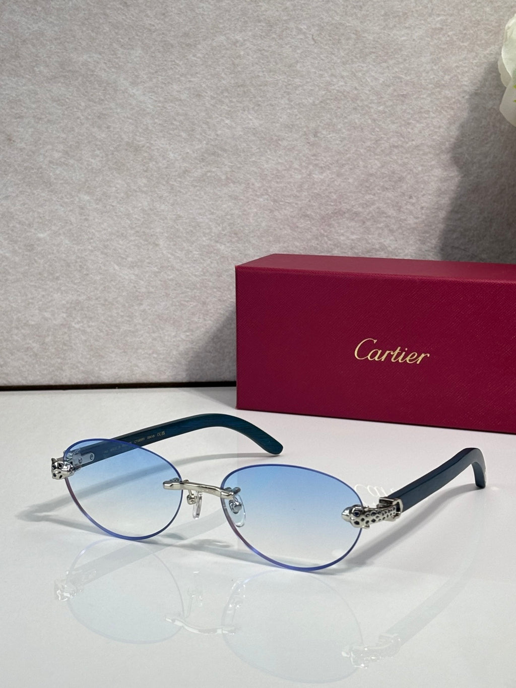 Cartier eyeglasses with blue frame and light blue lenses, silver-toned accents