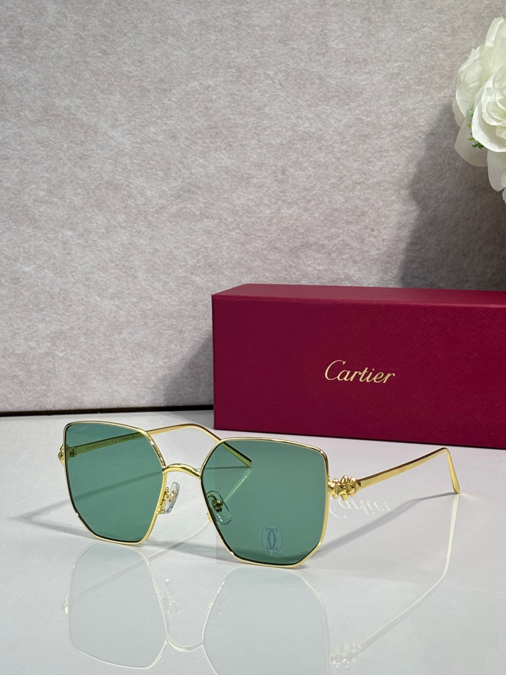 Rectangular sunglasses with gold frame and green mirrored lenses