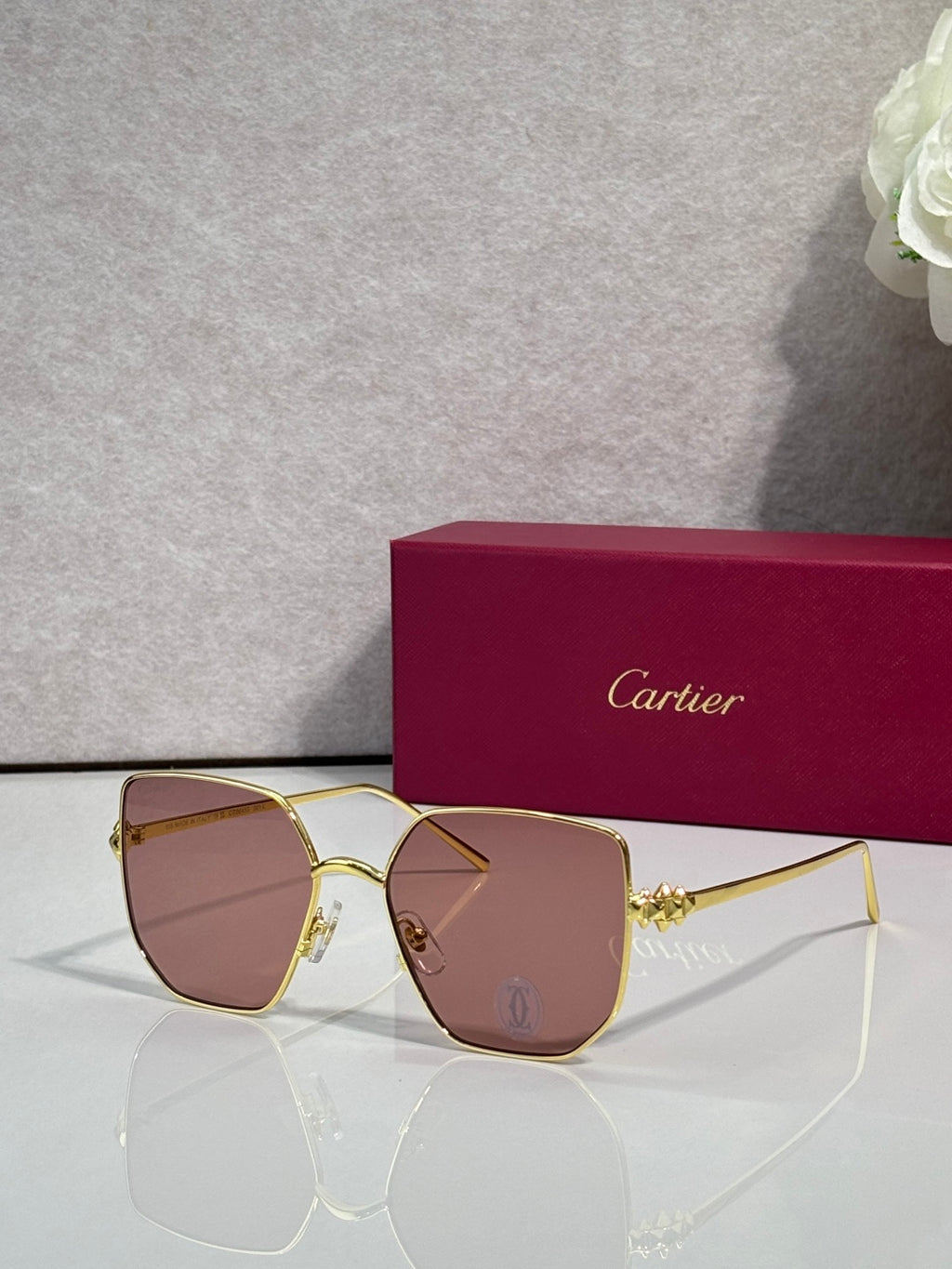 Rectangular sunglasses with gold frame and warm brown mirrored lenses