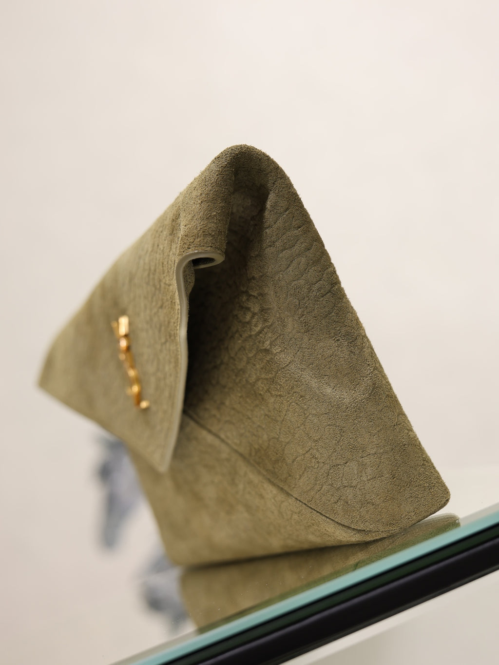 Olive textured leather clutch bag with open top and gold monogram detail