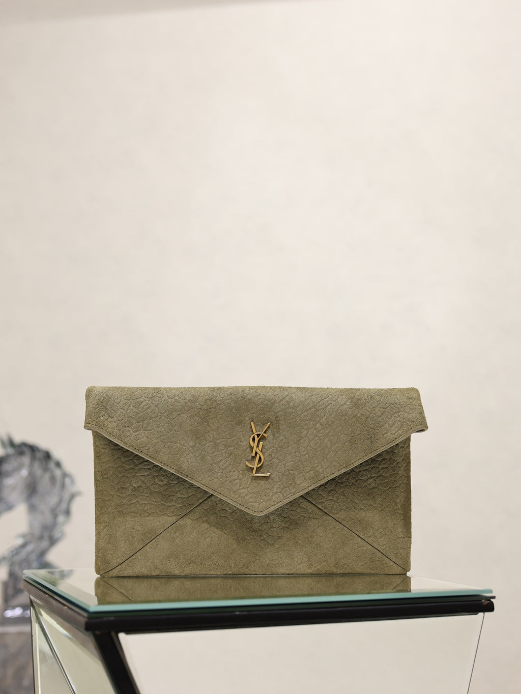 Olive textured leather envelope clutch bag with gold YSL logo on front flap