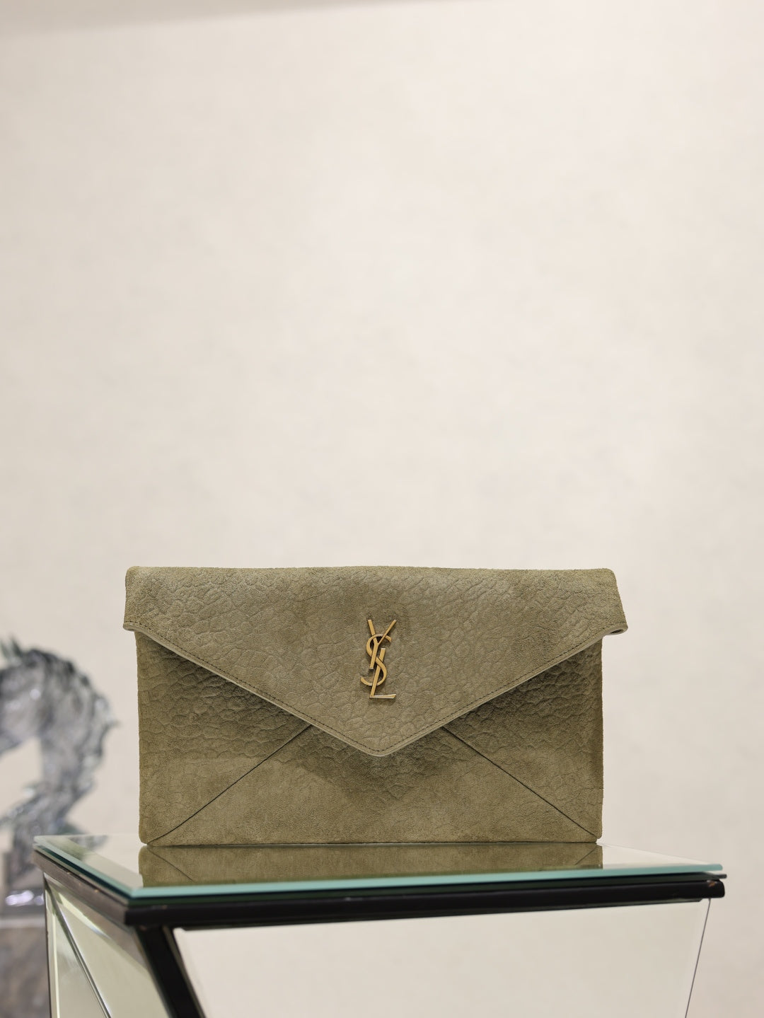 Olive textured leather envelope clutch bag with gold YSL logo on front flap