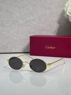 Cartier round metal glasses with gold frame and dark gray lenses