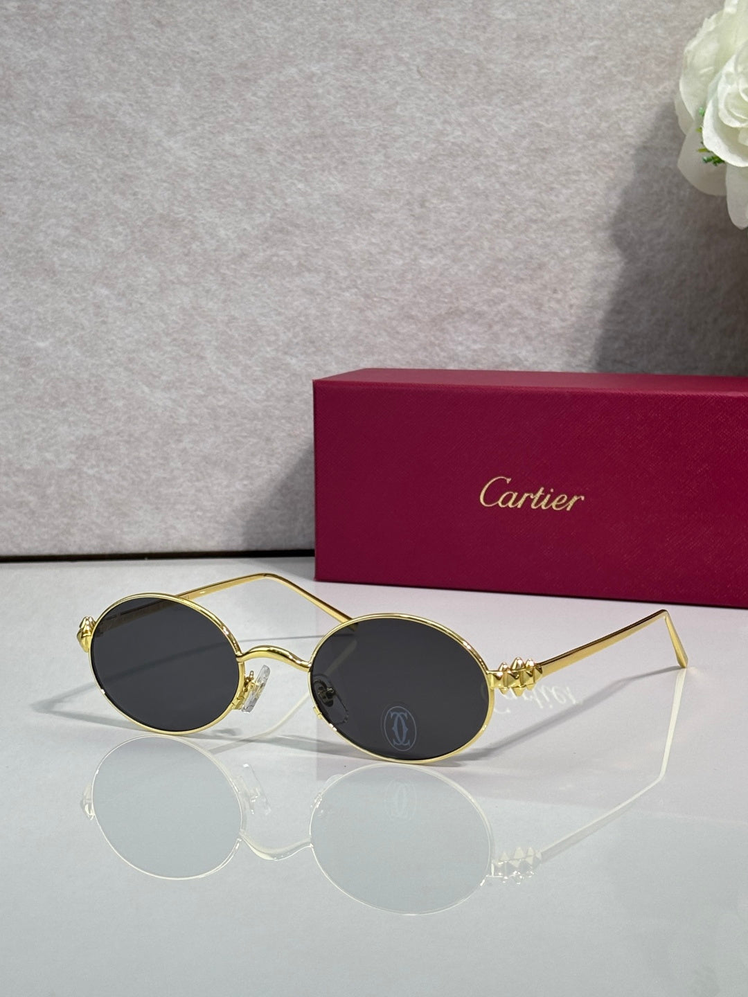 Cartier round metal glasses with gold frame and dark gray lenses