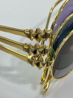 Close-up of gold temple detail on Cartier round glasses with dark lenses