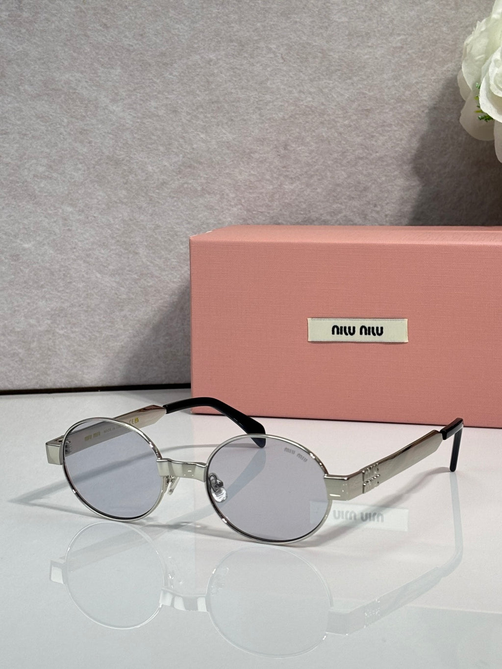 MiuMiu round sunglasses with silver-tone frame and clear lenses