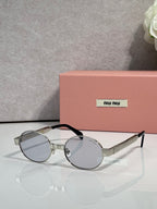 MiuMiu round sunglasses with silver-tone frame and clear lenses